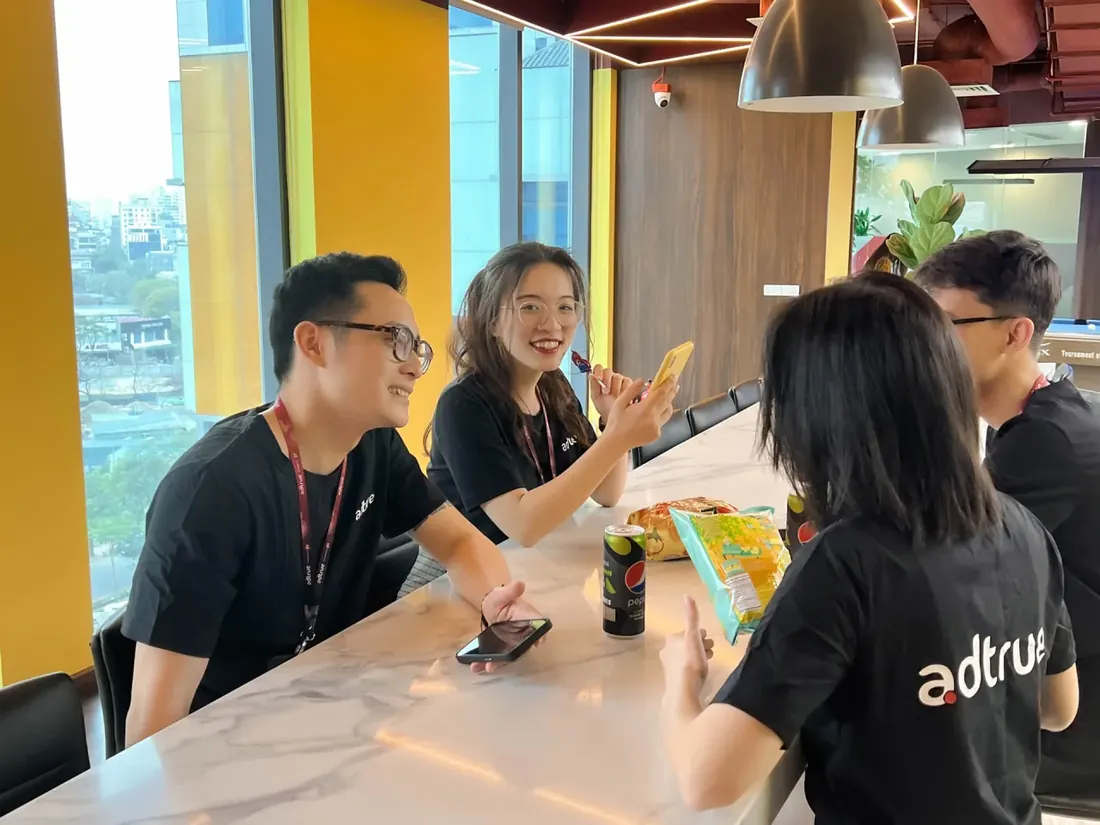 Colleagues sharing ideas over coffee in the AdTrue pantry